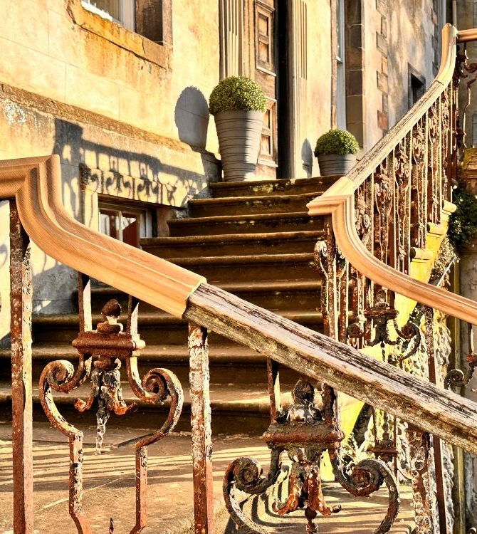 New timber handrail fitted to a historic wrought iron staircase balustrade